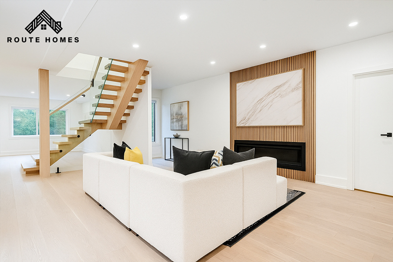 Modern home renovation in King City featuring open living room, custom staircase, and bright natural interiors by Route Homes.