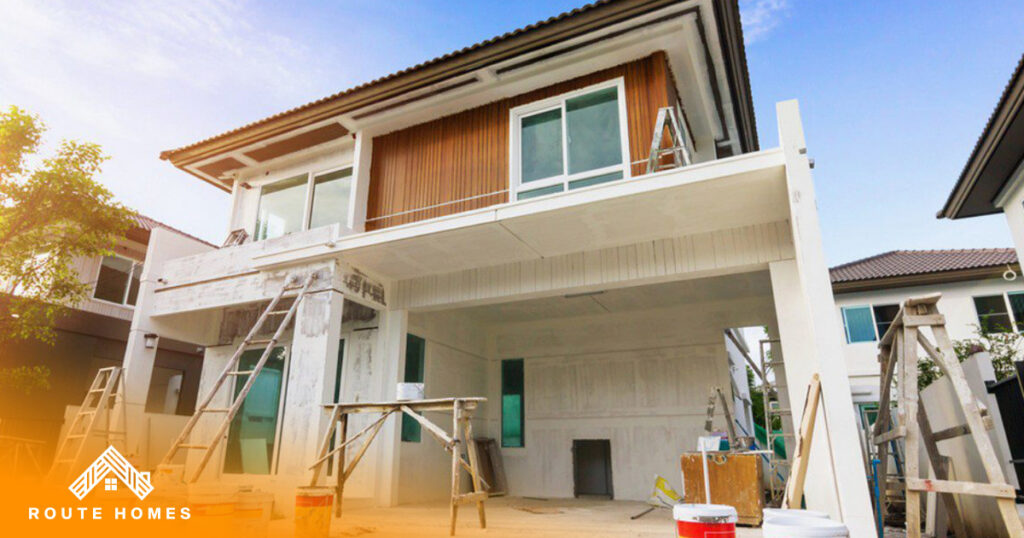 Can You Live in Your House During a Renovation? 5 House exterior under renovation with scaffolding and ladders